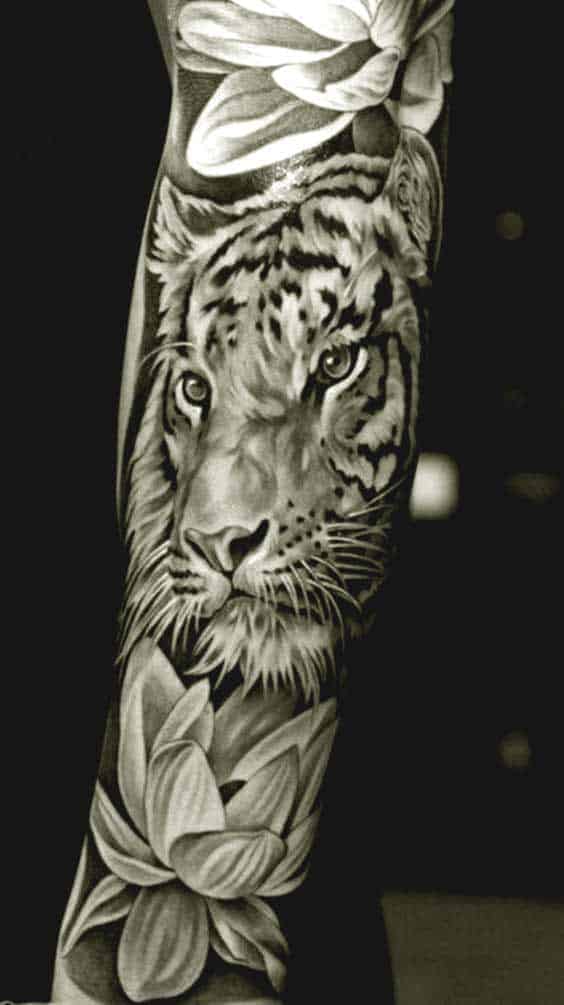 Best Tiger Tattoos For Men And Women Tiger and lotus flower tattoo on inner arm for men