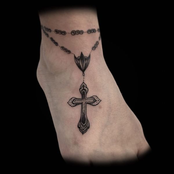 cross tattoo on foot